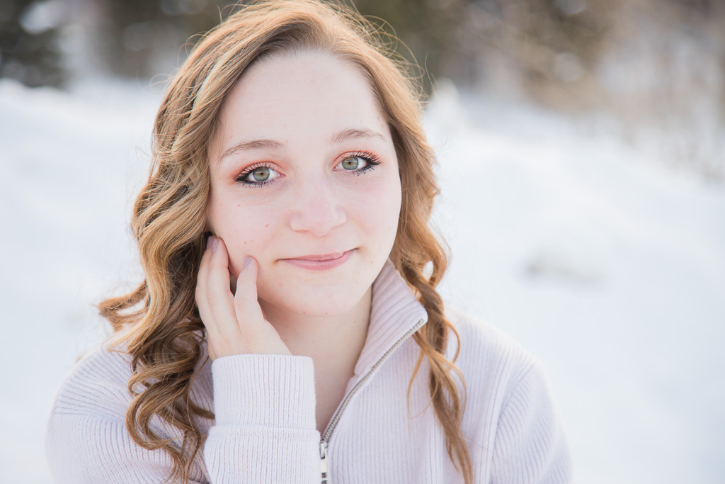 Girl with hand on face in snow