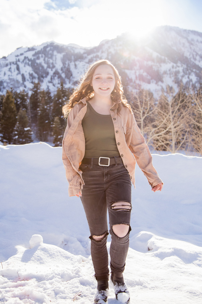 Girl walking in front of snowy mountains 